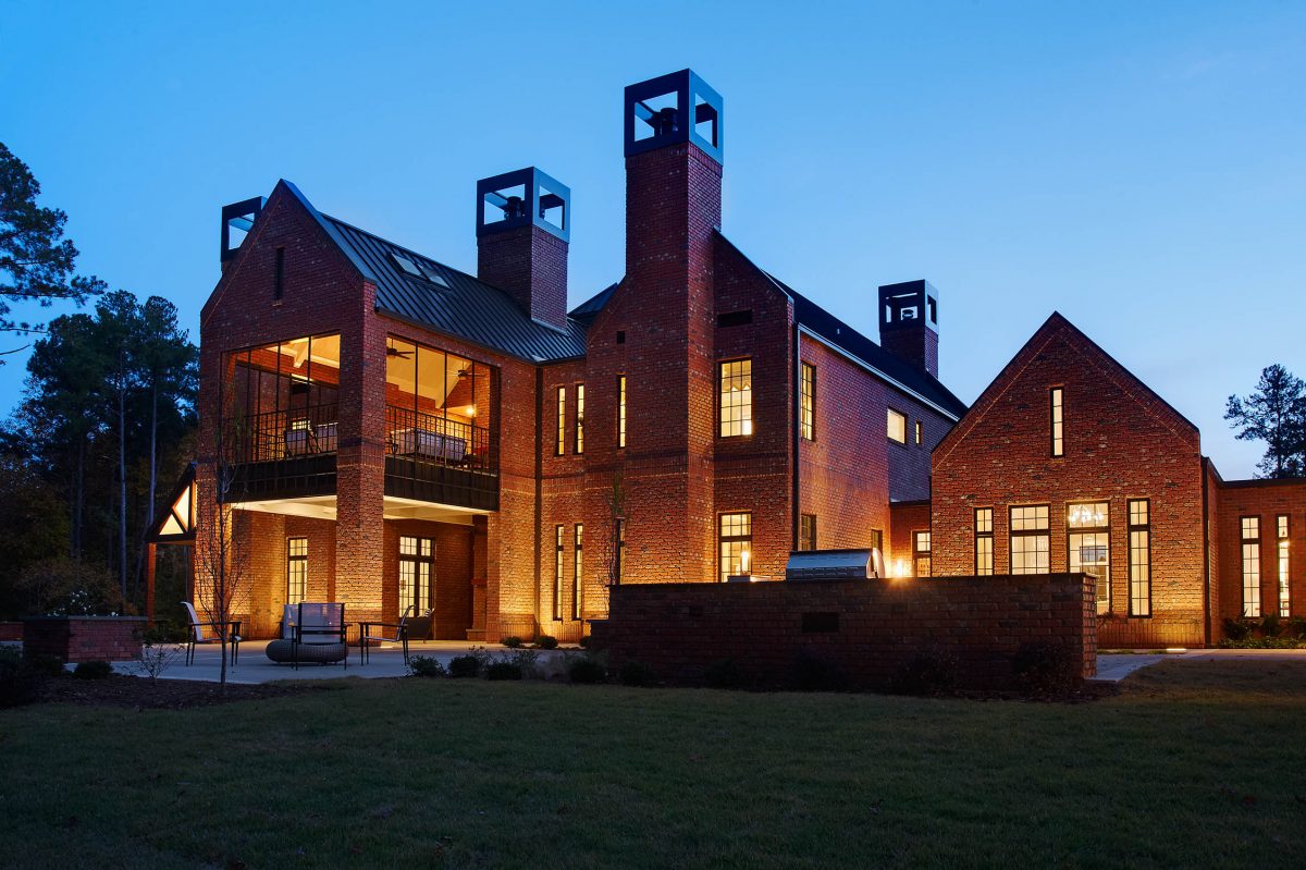 Exterior at night at the N.C. State Chancellor's Residence in Raleigh. Custom built by Rufty Homes.