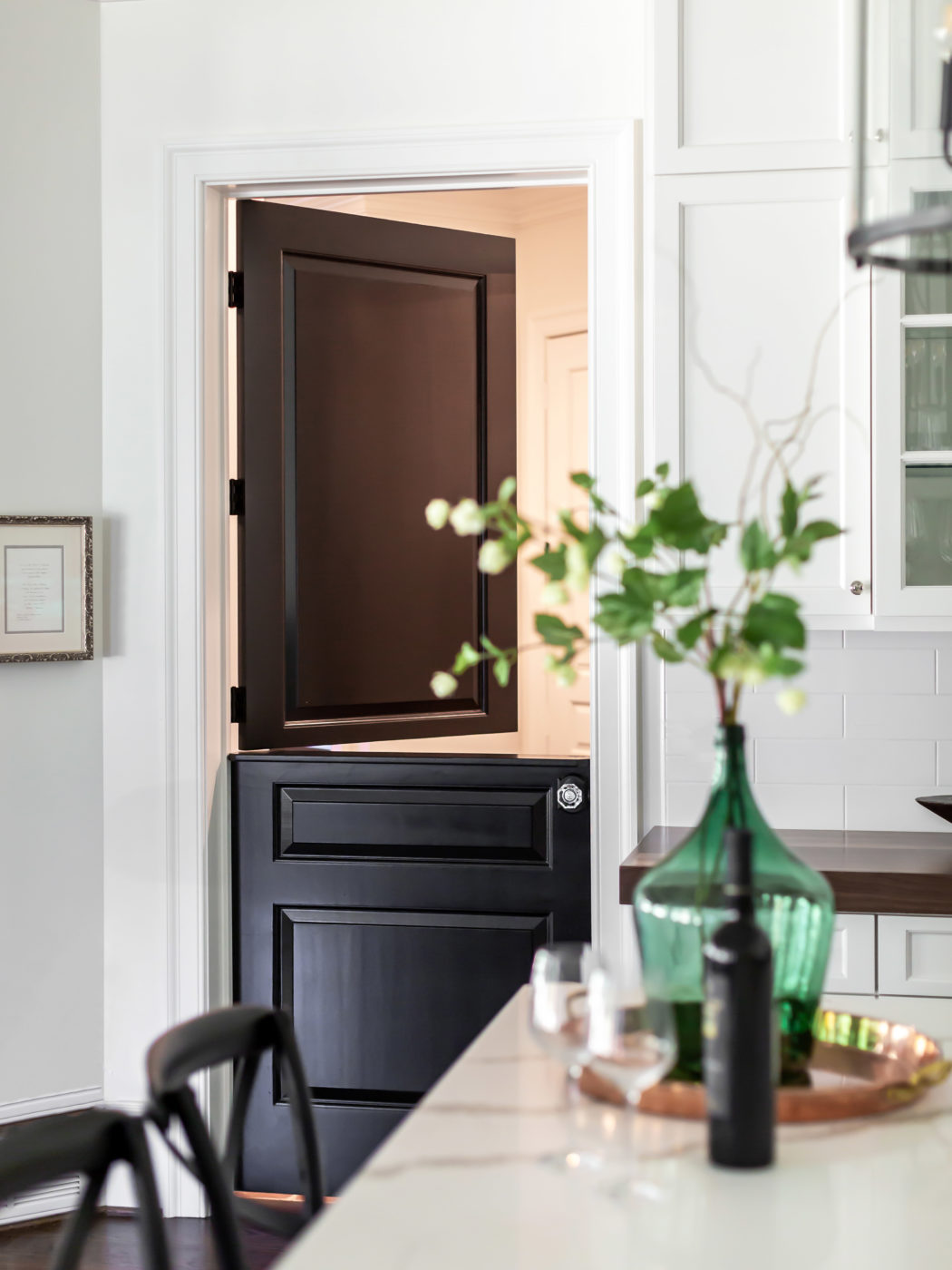 Split black kitchen door in a custom luxury home inside the beltline of Raleigh, NC