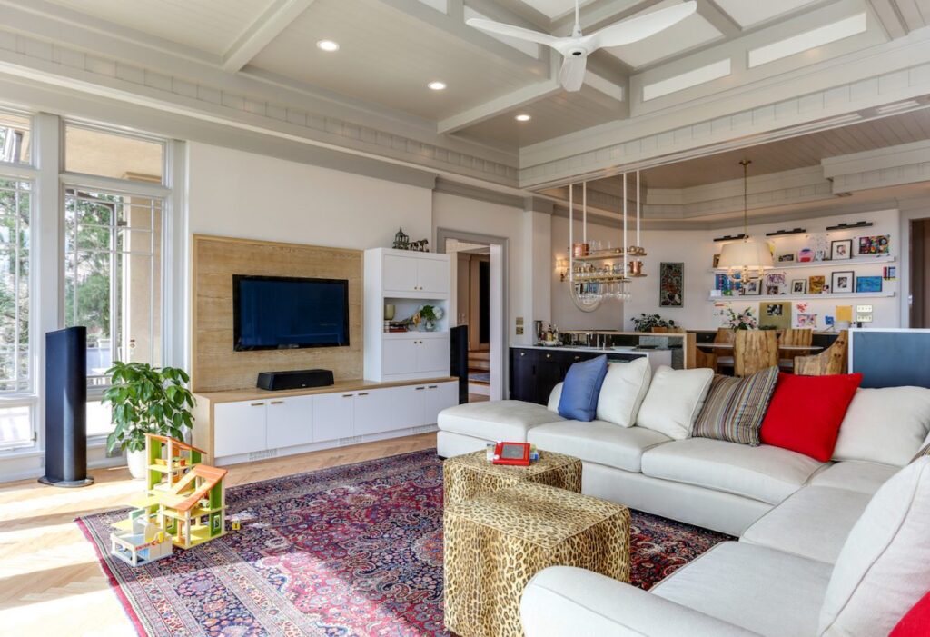 couch and tv in a large living room of a luxury home remodel
